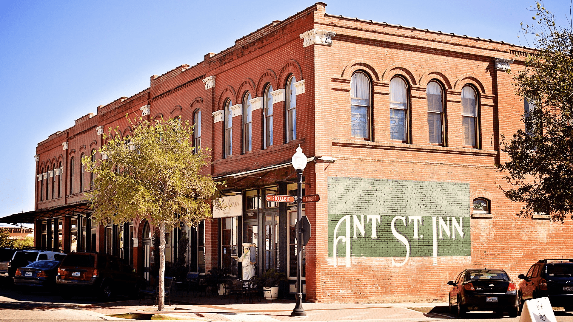 Historic brick building with "ANT ST. INN" painted on the side.